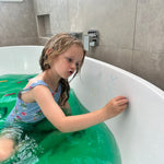 Child drawing in bath tub