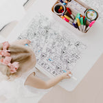 Child colouring princesses and fairies on a Seek n Spot reusable silicone mat